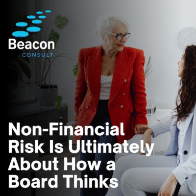 Two women sit talking at a desk, non financial risk message